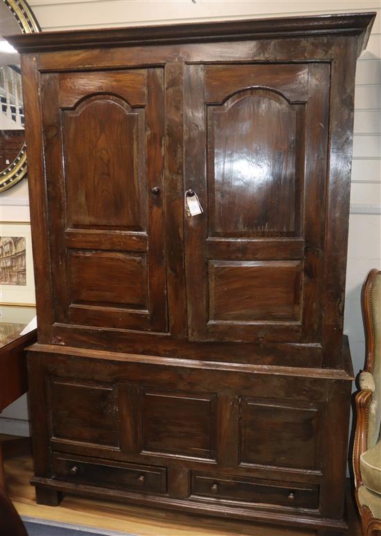 A mid 18th century walnut press cupboard, with two panelled doors and two base drawers, on stile feet W.135cm